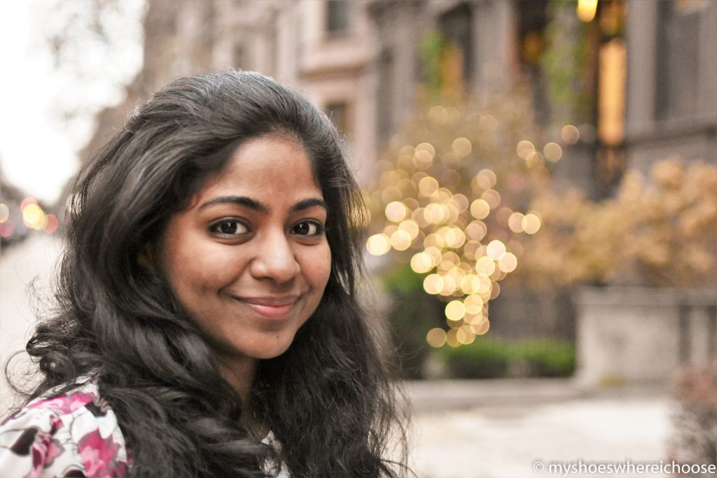 Girl with fairy lights in the background creating a beautiful bokeh effect - photography gear for bokeh