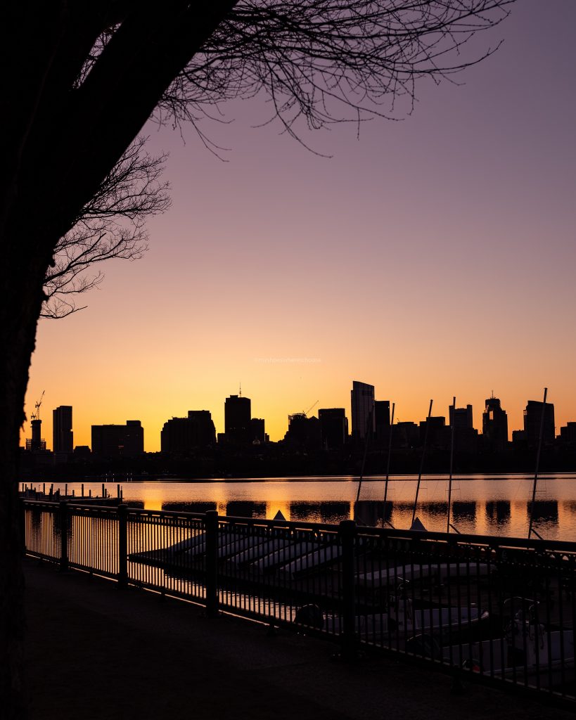 Boston skyline silhouette at sunrise as seen from Cambridge